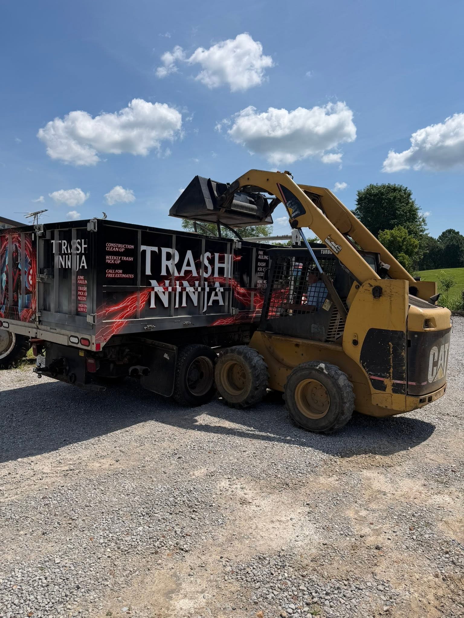 Trash Ninjas LLC mover standing in front of a fully loaded moving truck